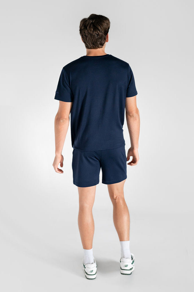 A person wearing navy blue merino wool lounge shorts