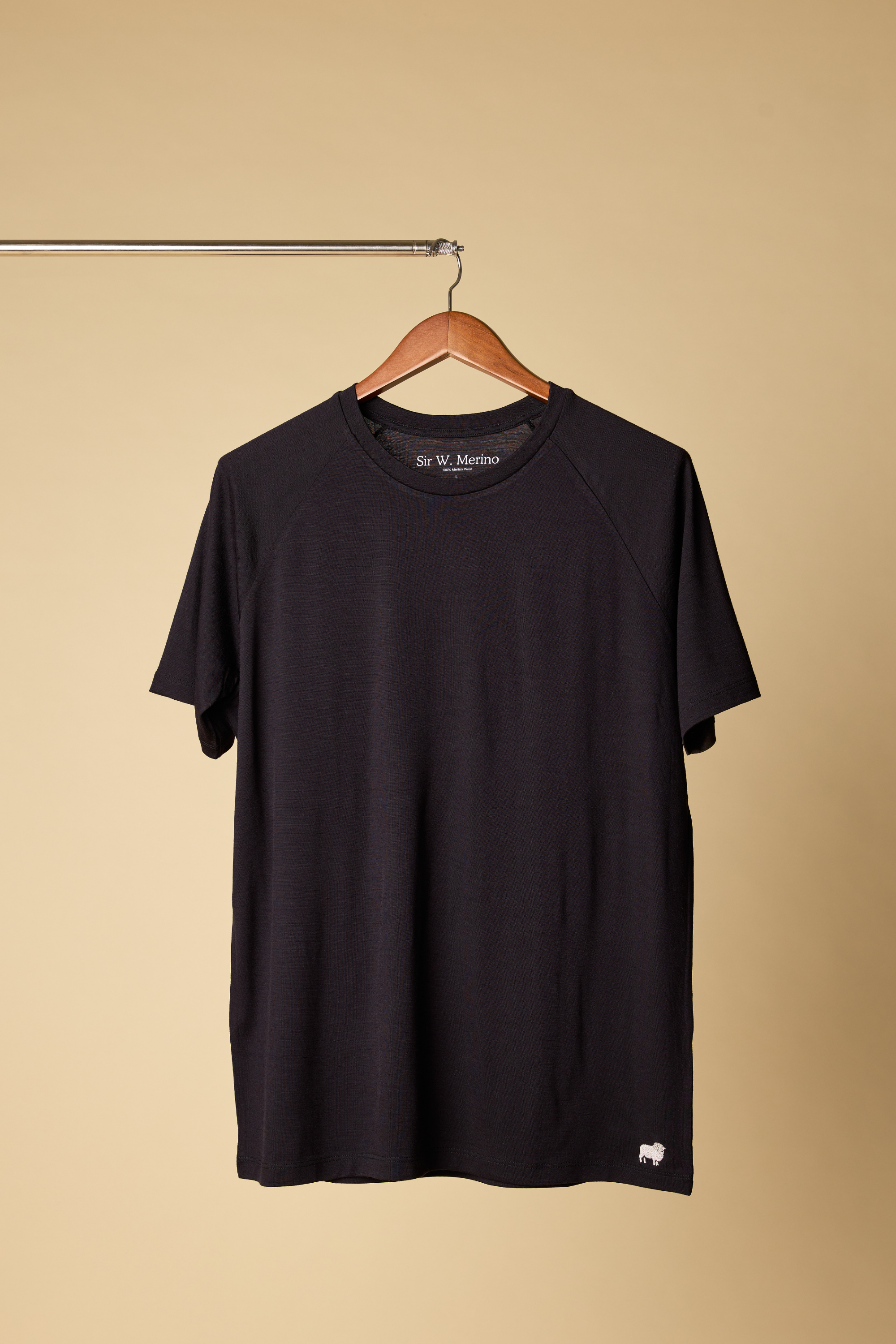 Black Sir W. Merino t-shirt on a wooden hanger
