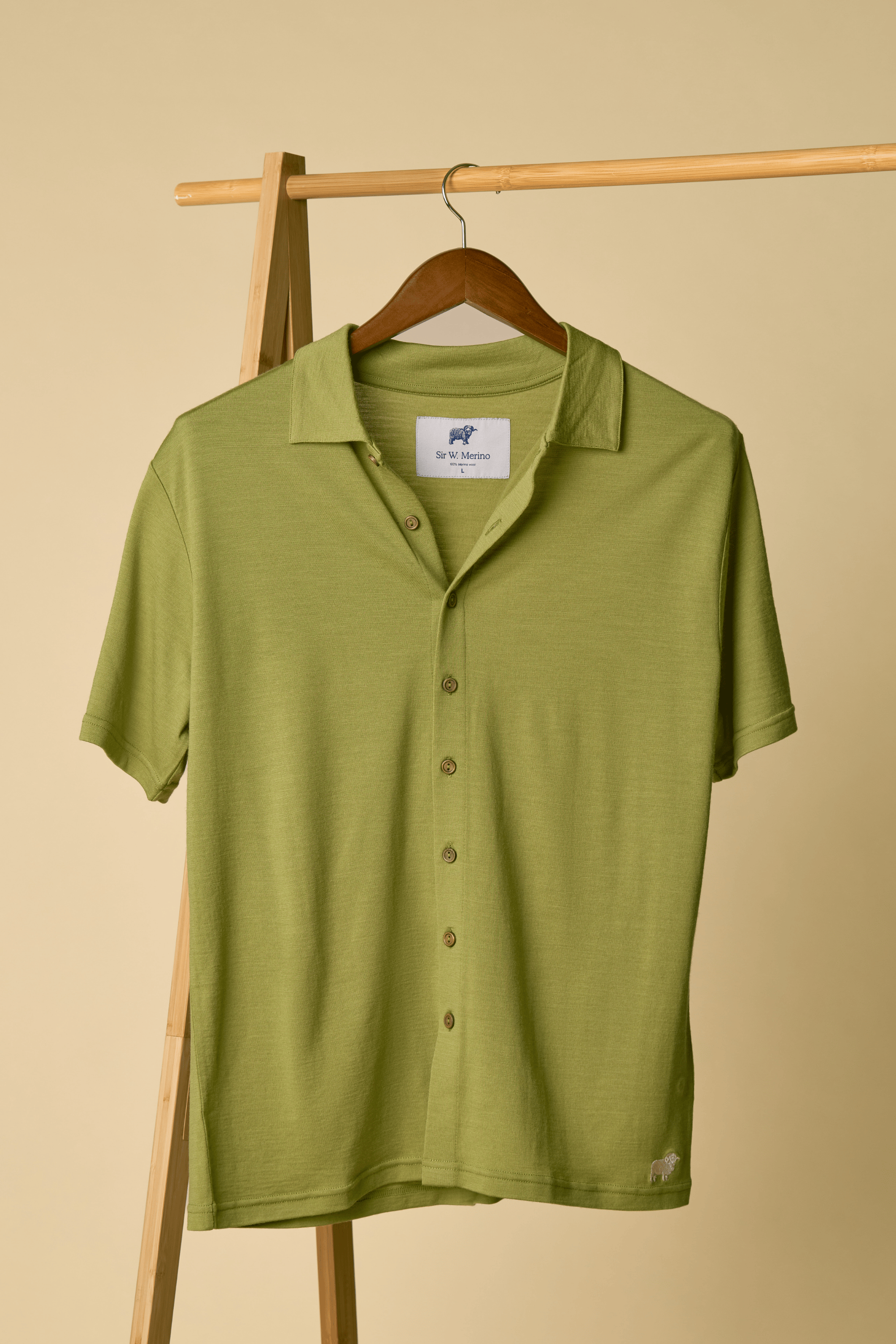 Green Sir W. Merino Bruce Olive Green shirt on a wooden hanger