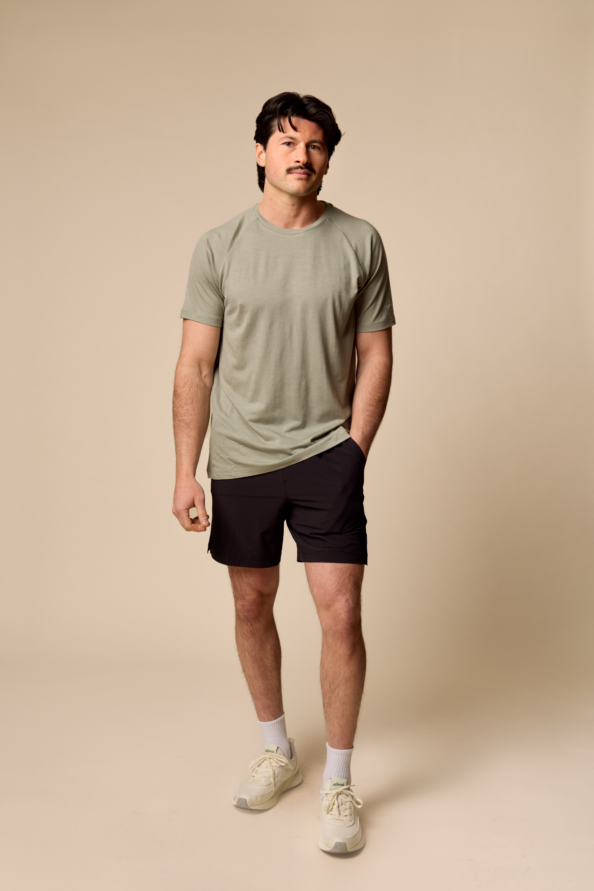 Man wearing Sir W. Merino cassius shadow grey tee and black shorts