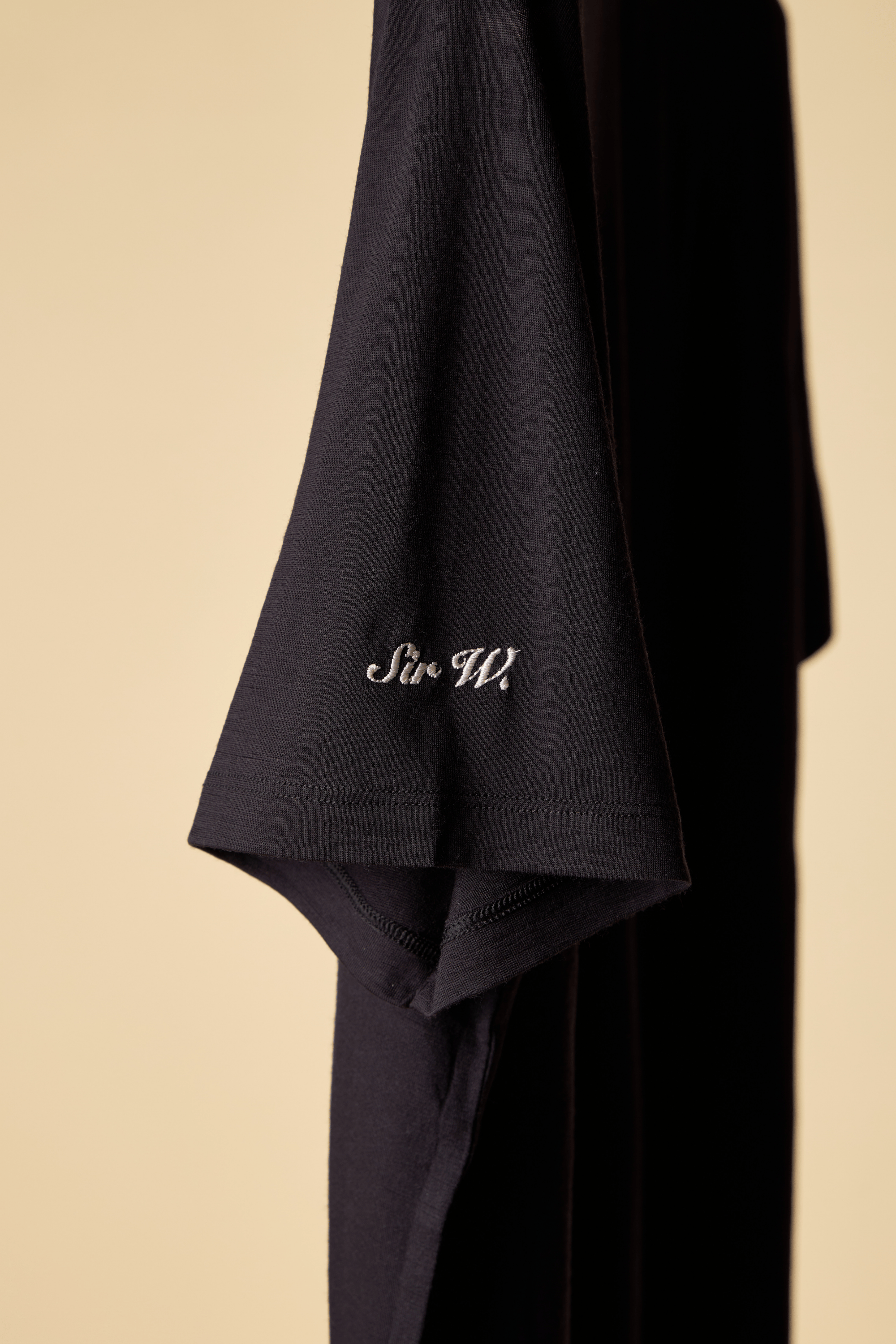Black Sir W. shirt with 'Sir W' branding
