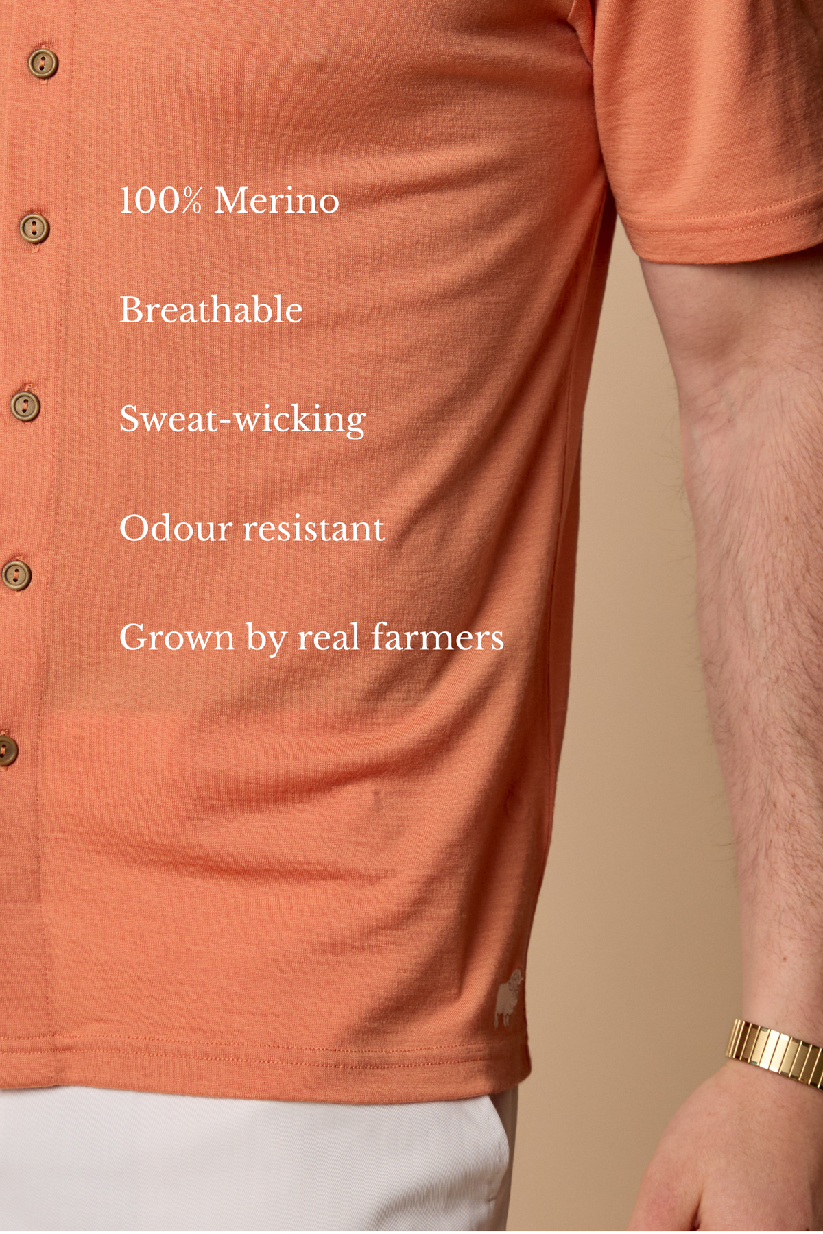 Man wearing Sir W. Merino Bruce Caramel shirt and white pants and holding watch #Color_Caramel
