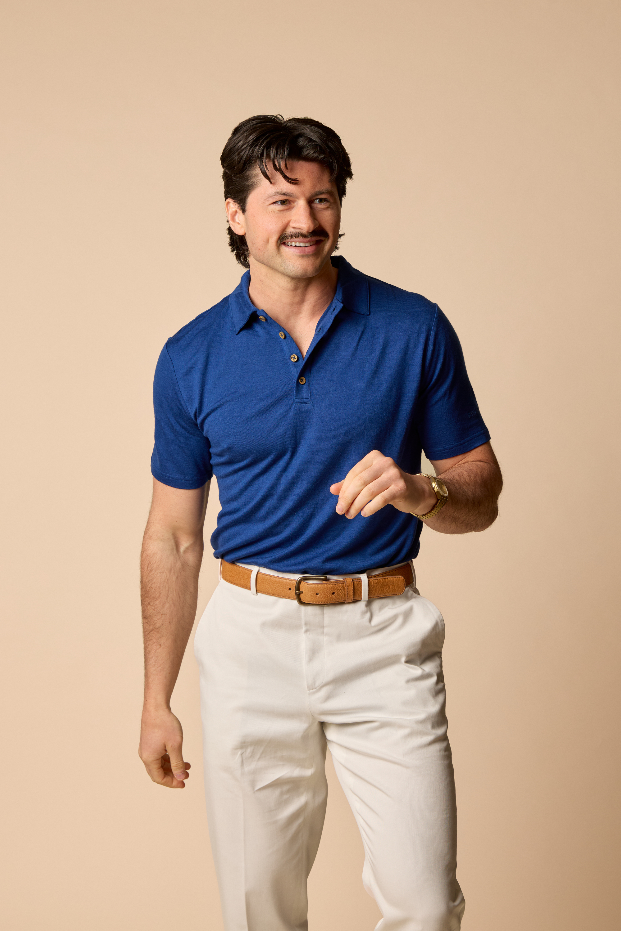 Sir W. Merino George polo in royal blue, front view, modeled by man standing