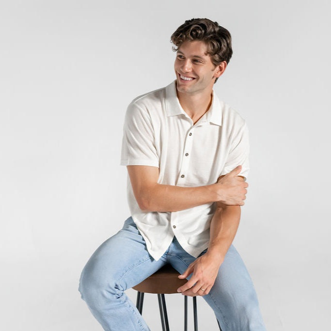 Model sitting with 100% Merino wool button down