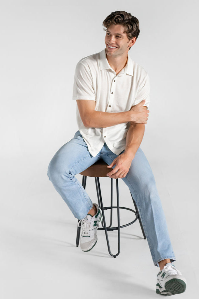 Model sitting with 100% Merino wool button down