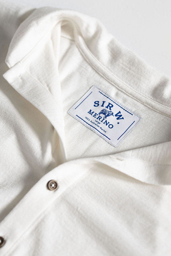 Up close shot of a white Merino wool button down shirt