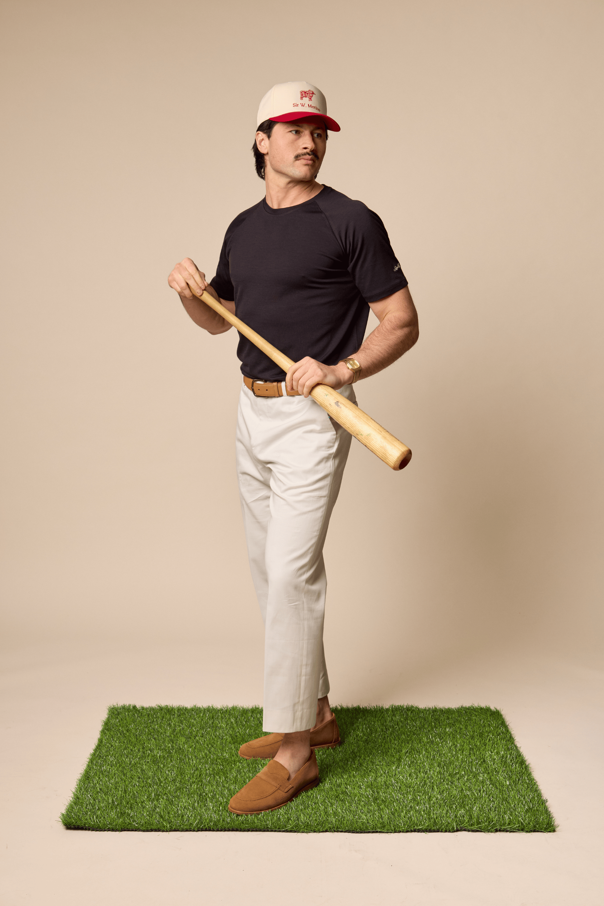 Man wearing Sir W. Merino Cassius Black Athletic shirts holding a baseball bat 