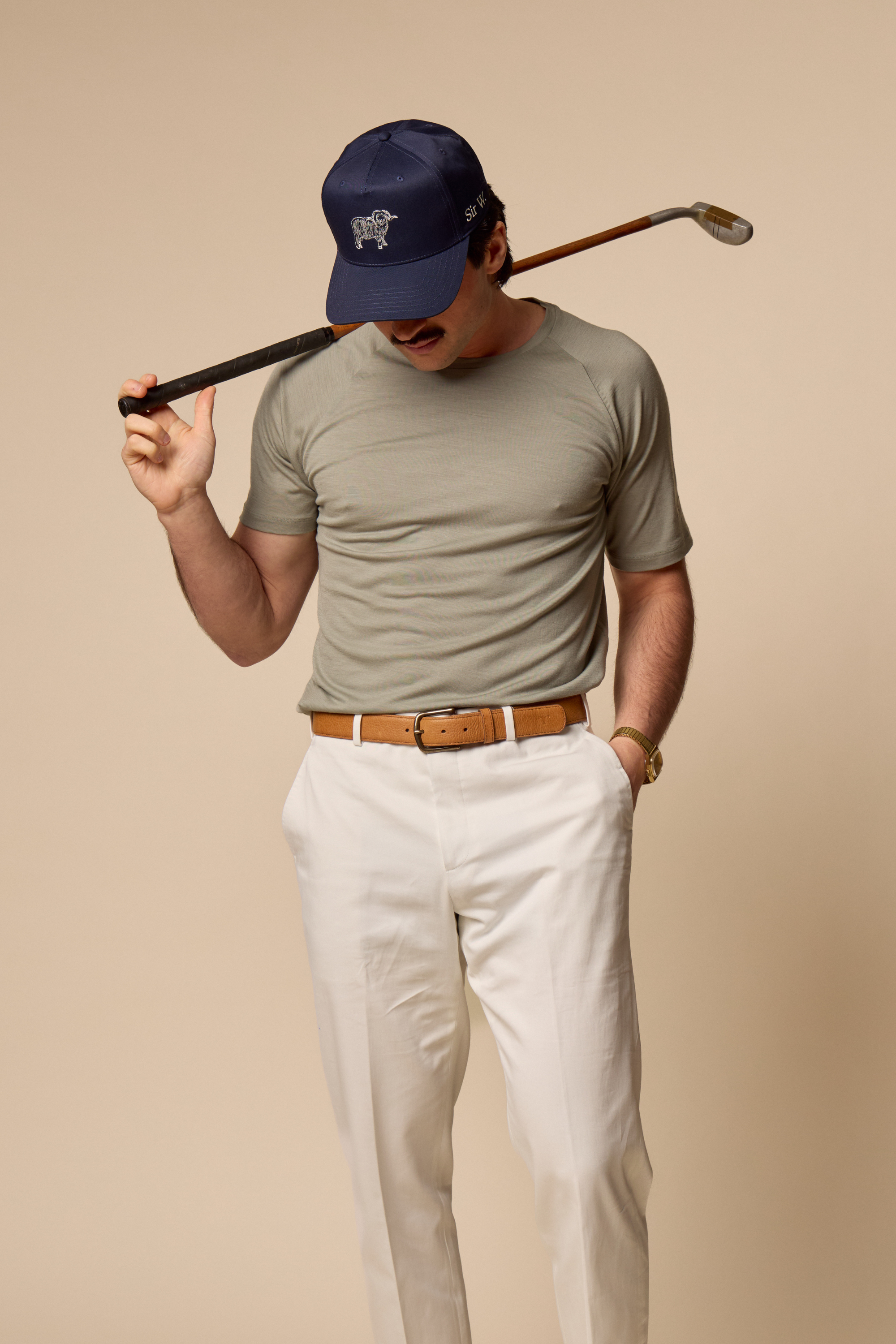 Sir W. Merino cassius shadow grey tee, with white pants and navy cap.